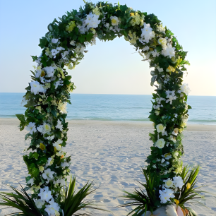 white wire u shaped wedding arch on beach 