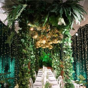 gold mirror balls hanging over a dinning table photoshoot