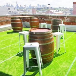 rooftop wine barrels and black bar stools