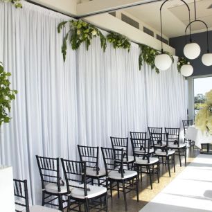 wedding ceremony white carpet black chairs