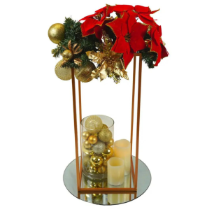 red poinsettia and gold baubles in table centrepiece 