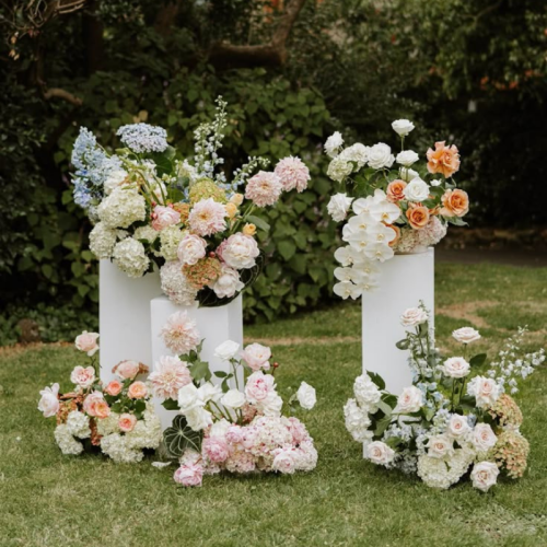 white pillars with pastel wedding florals
