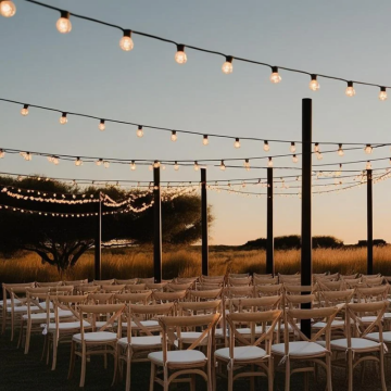 festoon lights over wedding ceremony