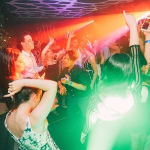 smoke machine creating light beams across dancefloor