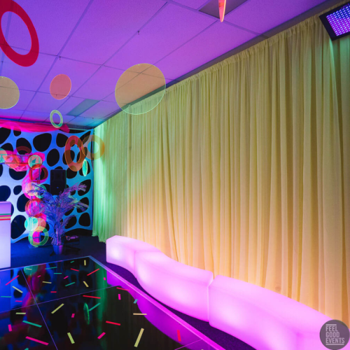 fluro party with yellow chiffon draped walls